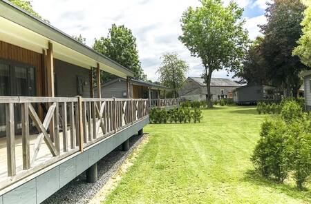 Chalets with covered verandas at the Moulin de Hotton holiday park in the Ardennes