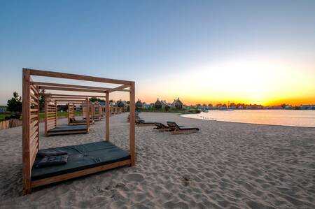 Enjoy the lounge beds on the cabana beach of holiday park Oesterdam Resort