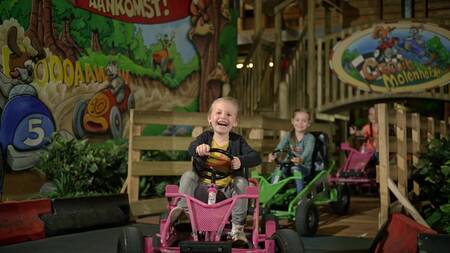 Children on go-carts in the indoor playground "Kids Valley" at the Park Molenheide holiday park
