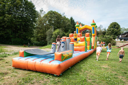 Children play on a bouncy castle at the Petite Suisse holiday park