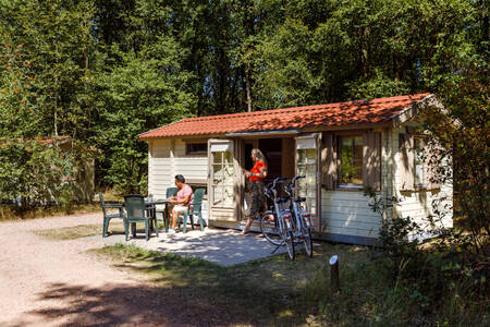 The family relaxes in the garden of a chalet at holiday park RCN De Noordster