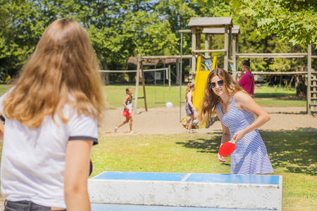 Children playing table tennis in the playground of holiday park RCN Le Moulin de la Pique