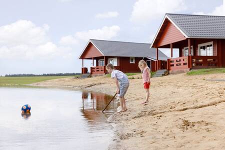 Children on the beach of the recreational lake of holiday park RCN de Flaasbloem