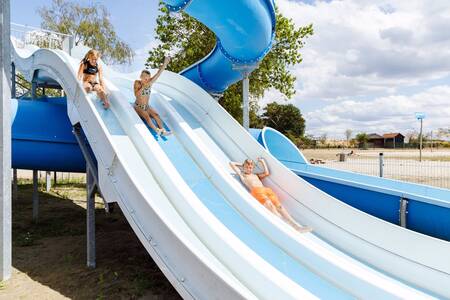 Children on the water slide that ends in the lake at holiday park RCN de Flaasbloem