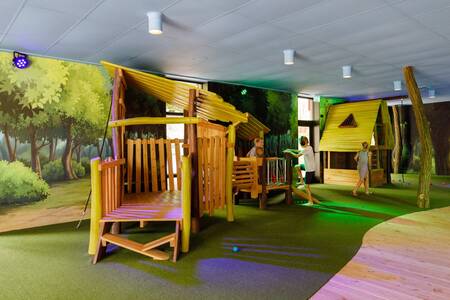 Children play in the indoor playground of holiday park RCN de Jagerstee