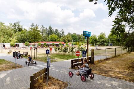 Children on go-karts on the roundabout at holiday park RCN de Jagerstee