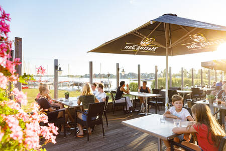 People on the terrace of the Brasserie at holiday park RCN de Potten