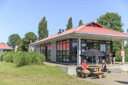 People on the terrace at the snack bar at holiday park RCN de Potten