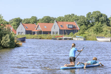 Two children paddling on the water at holiday park RCN de Potten