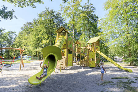 Children play in the large playground at holiday park RCN de Roggeberg