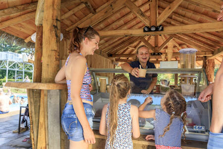 Children buy an ice cream at the ice cream parlor at holiday park RCN het Grote Bos