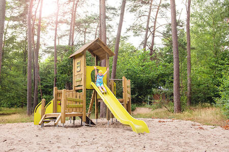 Child plays in a playground at holiday park RCN het Grote Bos