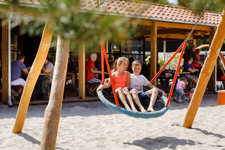 Children in the playground at Brasserie La Forêt at holiday park RCN het Grote Bos