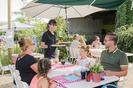 Family on the terrace of the restaurant at holiday park RCN la Ferme du Latois