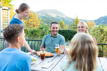 Family eating on the terrace of the Bistro at holiday park RCN les Collines de Castellane
