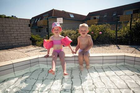 Children in the outdoor pool at Roompot Apartment complex Bosch en Zee