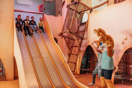 Children on a slide in the indoor playground of the Roompot Beach Resort Nieuwvliet-Bad
