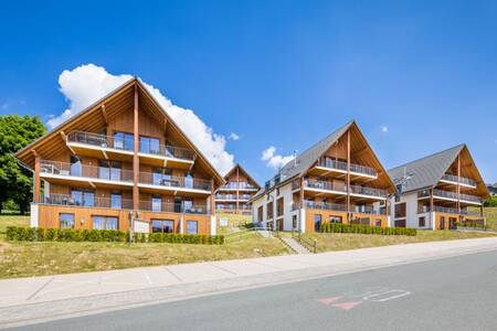 Apartment building in the summer at the Roompot Bergresort Winterberg holiday park
