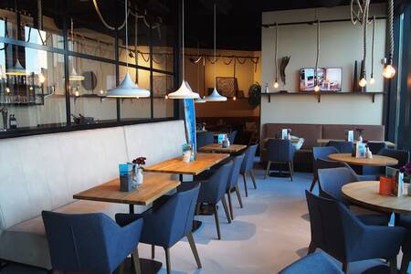Tables with chairs in the attractive restaurant of Roompot Bloemendaal aan Zee
