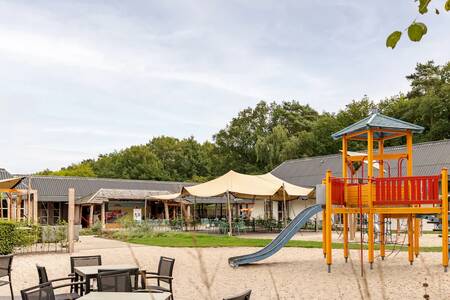 Playground with terrace at the central building at the Roompot Bospark Lunsbergen holiday park