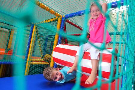 Children play in the indoor playground of the Roompot Bospark de Schaapskooi holiday park