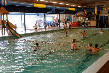 People swim in the indoor pool of the Roompot Bospark 't Wolfsven holiday park
