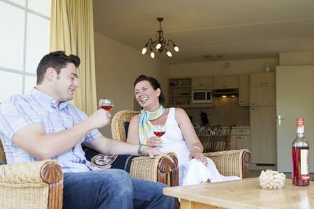 Have a drink in the living room of a holiday home at the Roompot Buitenhof Domburg holiday park