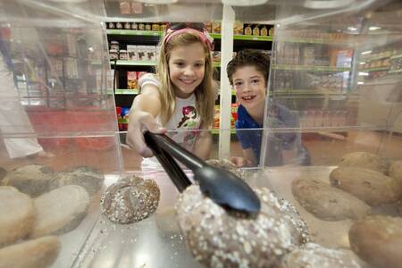 Children buy sandwiches in the supermarket at the Roompot Buitenhof Domburg holiday park
