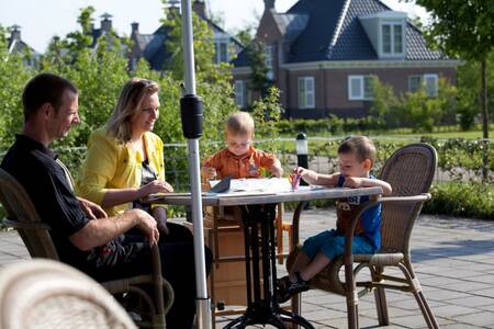 Family on the terrace of the restaurant at holiday park Roompot Buitenplaats De Hildenberg