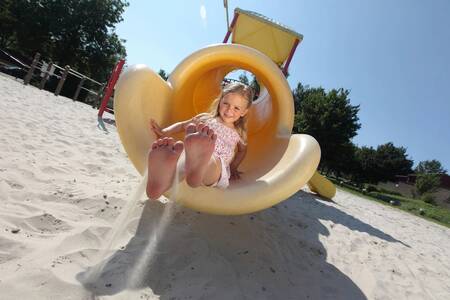 Child on the slide in the playground of holiday park Roompot Bungalow park Schin op Geul