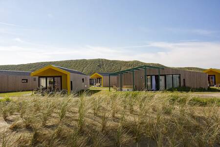 Detached holiday homes in front of the dunes at the Roompot Callantsoog holiday park
