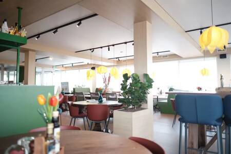 Tables with chairs in the restaurant of Holiday Park Roompot Callantsoog