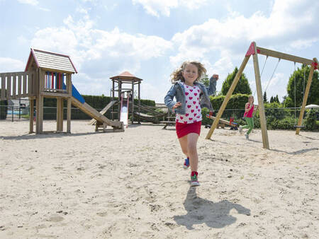 2 children play in the playground at the Roompot De Veluwse Hoevegaerde holiday park