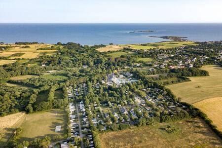 Aerial view of chalets at the Roompot Deux Fontaines holiday park with the sea on the horizon