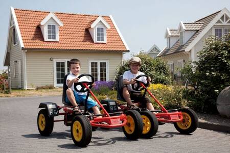 2 Children on go-karts at the Roompot Duynparc holiday park De Heeren van 's-Gravensande