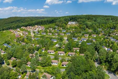 Aerial view of holiday homes on holiday park Roompot Eifelpark Kronenburger See and forest
