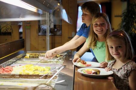 3 children package food in the buffet restaurant at Roompot Ferienresort Cochem