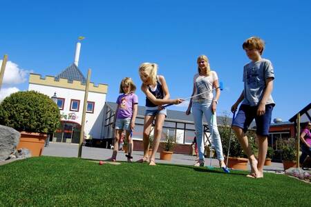 Children playing golf on the mini golf course of Roompot Ferienresort Cochem