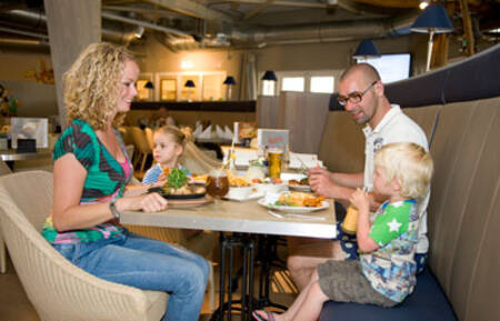 Family is eating in the restaurant of Roompot Holiday Park Boomhiemke