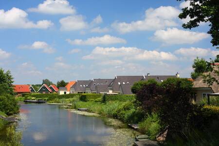 Detached holiday homes along a ditch at Roompot Holiday Park Emslandermeer