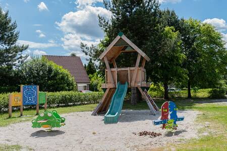 A playground with playground equipment and slide at Roompot Holiday Park Emslandermeer