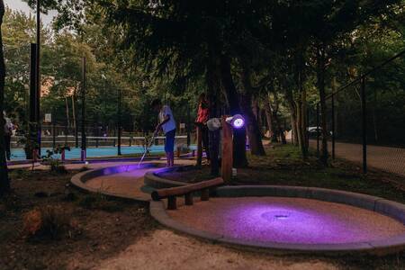 People play golf on the miniature golf course of Roompot Vakantiepark Kijkduin