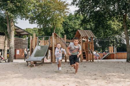 2 children play in a playground at Holiday Park Roompot Holiday Park Kijkduin