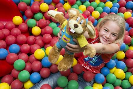 Girl in the ball pit of the Indoor playground at Roompot Vakantiepark Weerterbergen