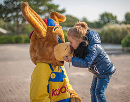Girl cuddles with Koos rabbit at holiday park Roompot Holiday park Boomhiemke