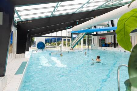 People swim in the indoor pool of Roompot Holiday Park Callassande