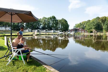 People fishing in the water at the Roompot Hunzepark holiday park