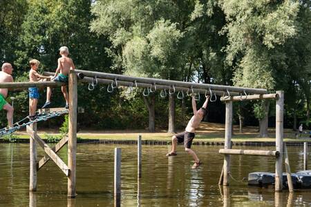 Children on wooden water play equipment at the Roompot Hunzepark holiday park