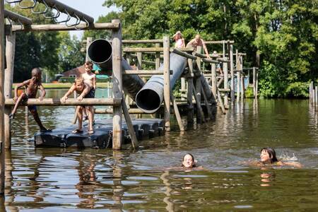 Children play in the water on a playground at the Roompot Hunzepark holiday park