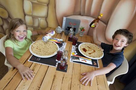 2 Children eat pancakes in the restaurant of holiday park Roompot Kustpark Egmond aan Zee